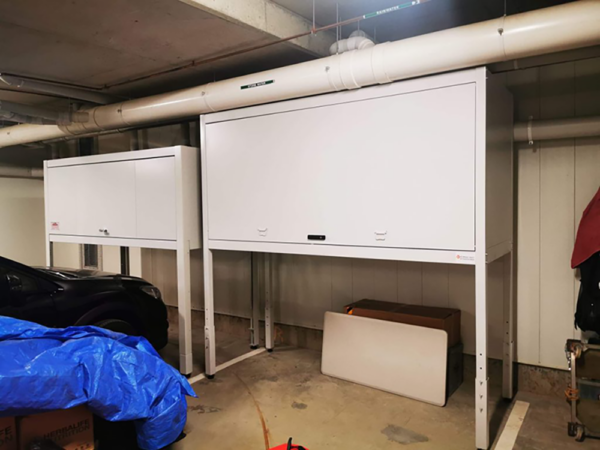 Compact storage cabinet for vehicles in parking garage.